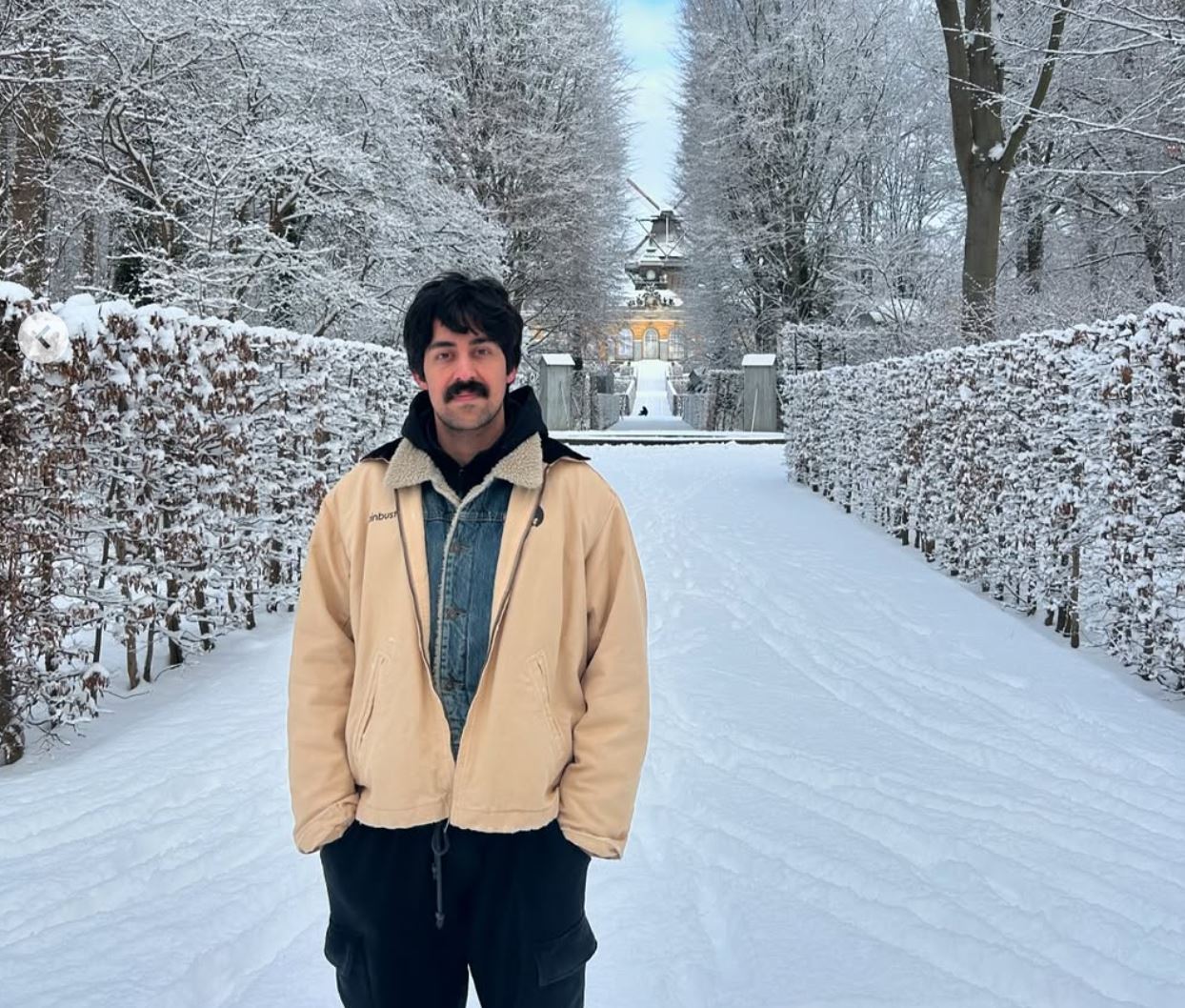 Mory Naimi wearing a Painbusterz jacket in the snow.