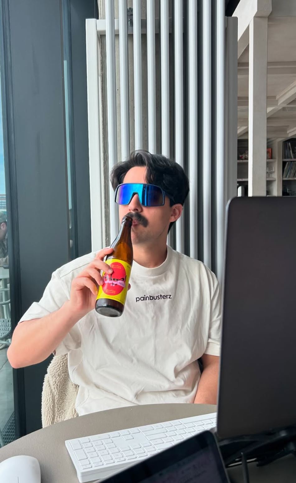 Mory Naimi drinking a beer after a busy day of appointments.